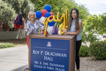 [Chris Tisch, assistant dean of the Mel and Enid Zuckerman College of Public Health, and college employee Gisela Ochoa take a moment to celebrate during the college’s virtual ceremony filming.]