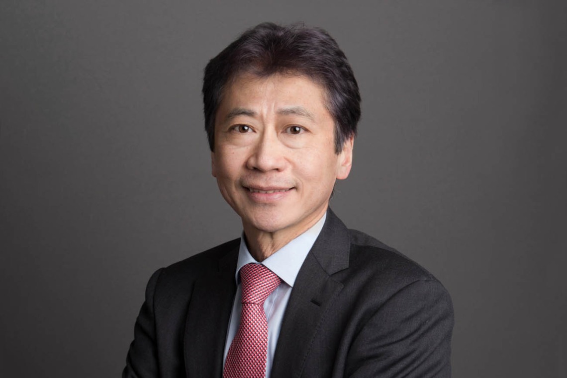 [Portrait of Asian-American man wearing a gray suit, red tie and blue dress shirt]
