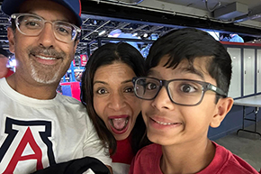 [Dr. Shroff and her husband, Puneet Shroff, MD, and their son during the U of A versus Utah men’s basketball game, Feb. 26, 2025.]