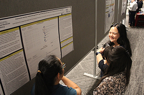 [Cardiology’s Olivia Hung, MD, PhD, chats with a couple of residents about their poster, “Endovascular Stenting vs. Medical Management for Type B Aortic Dissection vs. Long-Term Outcomes: A Meta-Analysis”]