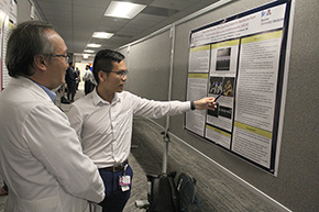 [Interventional cardiologist J.P. Keng Pineda, MD, PhD (left), talks with resident Thi Nguyen, MD, about his poster on “Beyond the Murmur: Distinguishing Subaortic Membrane from Hypertrophic Obstructive Cardiomyopathy”]