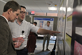 [COM-T vice dean for education and professor of general internal medicine, Kevin Moynahan, MD (left), talks to IM resident Paul Haddad, MD, about his research]