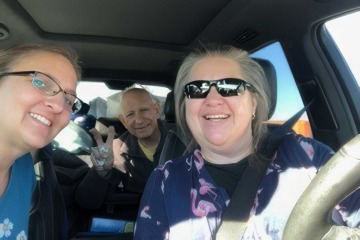 [A selfie of three people in a car]