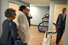 Dr. Parthasarathy tells (from left) Drs. Esther Sternberg, Michael Abecassis and Michael Dake about importance of exercise for proper sleep. The center has a treadmill and exercise bike for research patients.