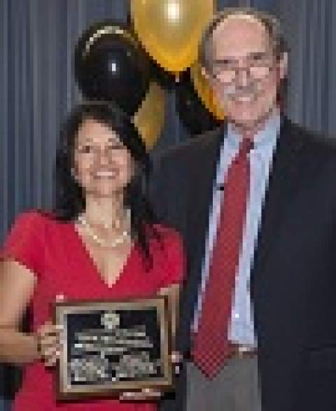 [Tejal Parikh, MD, one of the recipients of an AMES Grant for Medical Education Research, with Paul St. John, PhD, AMES chair.]