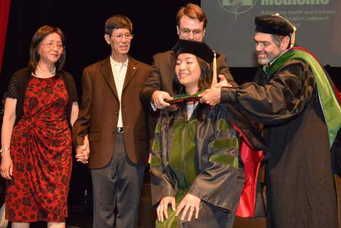 [Elaine Situ-LaCasse, MD, receiving her medical degree at the Class of 2013 convocation ceremony]