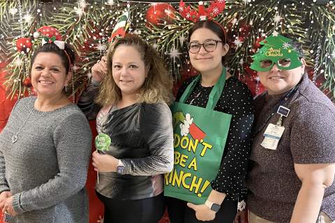 [Division of Gastroenterology staff at holiday photo booth they're hosting Dec. 20-21, 2023, at University of Arizona College of Medicine – Tucson]