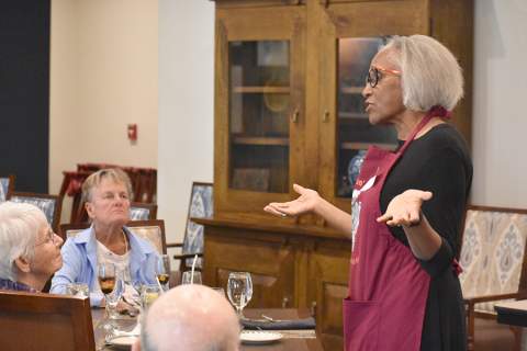 [Juanita Merchant, MD, PhD, talks to attendees at Docs in the Kitchen culinary demonstration for healthy eating at the Hacienda at the River retirement community in June 2023.]