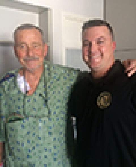 [Robert Freel with one of first responders who saved his life.]