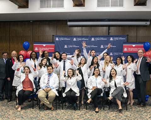 [Last winter’s PCP Scholarship winners from the UArizona College of Medicine – Tucson celebrate with college and health sciences leaders. (Photo: Noelle Haro Gomez/University of Arizona Health Sciences)]