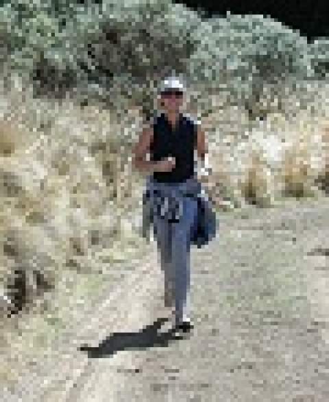 [Woman walking on a trail in the desert]