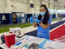 [Glenda Perez draws up a COVID-19 vaccine at the University of Arizona vaccination clinic on Monday, Sept. 19, 2023. (Photo by Hannah Cree from El Inde Arizona, stories from Southeastern Arizona by U of A School of Journalism students)]