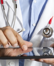 Physician using EHR on electronic tablet