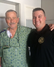 [Robert Freel with one of first responders who saved his life.]
