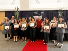 [Dr. Michael Abecassis, dean of the College of Medicine – Tucson (center), joins all the college's staff award of excellence nominees for a group photo, showing their Wildcat pride.]