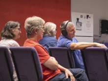 [Four people, including Mel Hector, MD, of the University of Arizona’s College of Medicine – Tucson, watch a reading of Dr. Hector’s play.]