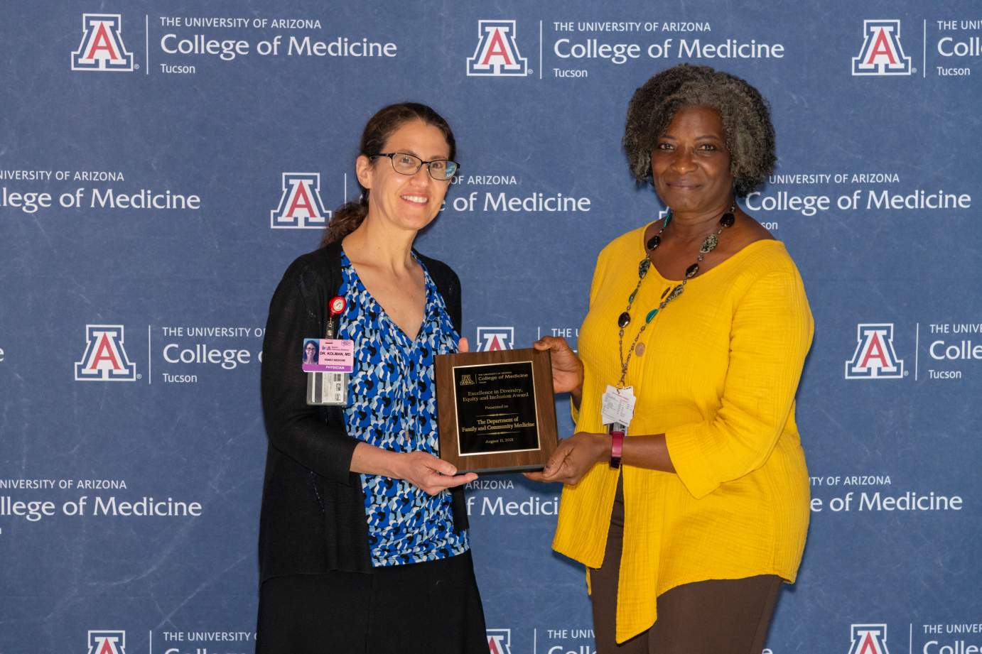 [Dr. Karyn Kolman accepts the Awards for Excellence in Diversity, Equity, and Inclusion for the Department of Family and Community Medicine presented by Dr. Victoria Murrain.]
