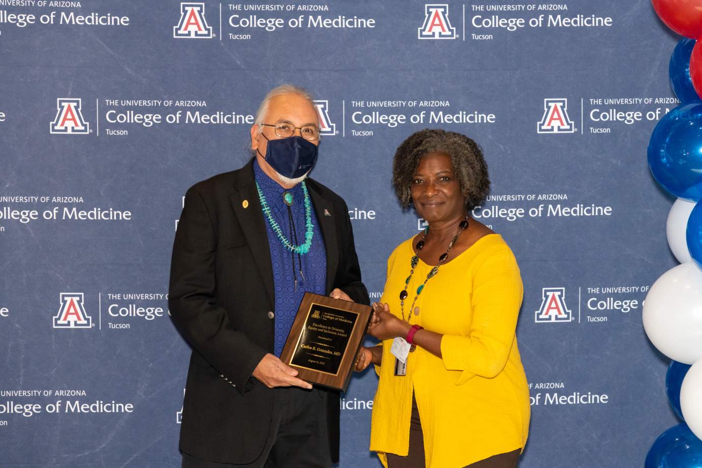 [Dr. Carlos Gonzales is presented with the Awards for Excellence in Diversity, Equity, and Inclusion by Dr. Victoria Murrain]