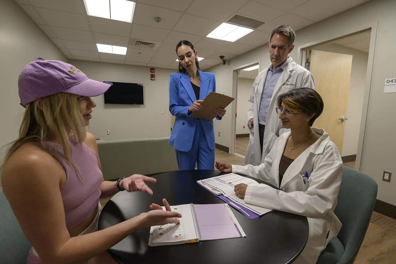 (Front right) Shivani Desai, a research assistant in the Social, Cognitive, and Affective Neuroscience Lab, practices administering an IQ test in the new facility to Darby Wolocko (in pink hat) as William D. “Scott” Killgore, PhD, director of the SCAN Lab, and lab technician Kymberly Henderson-Arredondo observe.