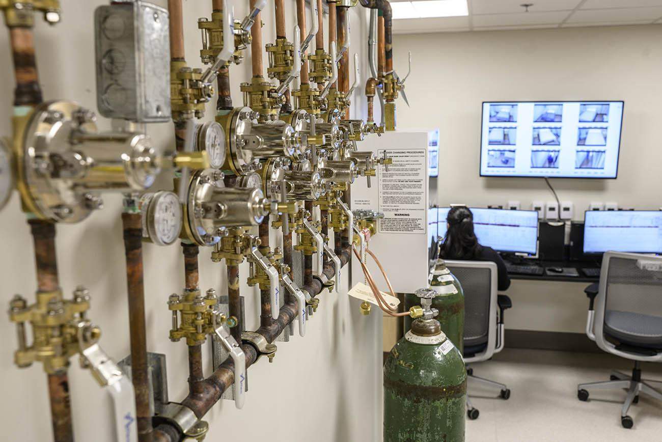 One of the features of the new facility is a high-tech control room that offers multiple monitors for observing study participants, an array of valves for controlling gasses in the sleep rooms, and the ability to test blood and administer drugs remotely.