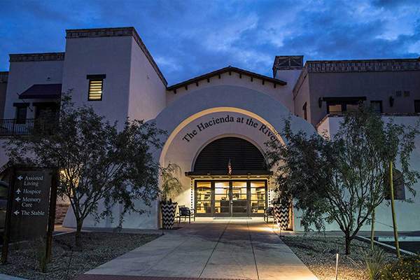 Evening photo of entrance to Hacienda at the River, a Watermark retirement community in Tucson, Arizona (Courtesy of Watermark Retirement Communities)