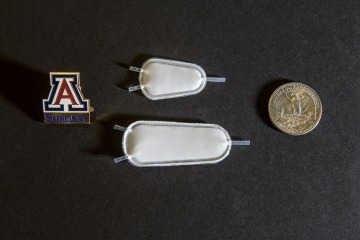 [Two samples of a synthetic implantable pouch, which would be infused with insulin-producing cells as a therapy for Type 1 diabetics. (Photo, UArizona Health Sciences, Kris Hanning)]