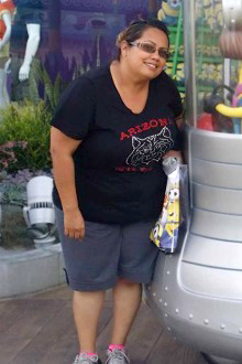 [Candid photo of Tina Teran standing next to a minion statue at a theme park]
