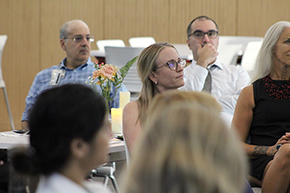 [The Division of Infectious Diseases’ Dr. Tirdad Zangeneh and Muhammad Al-Obaidi listen from the back row as guest speaker Kim Faith discusses taking their communications from interesting to influential.]