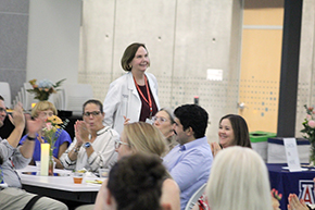 [Infectious Diseases’ Dr. Liz Connick approaches the podium at the 2024 Torchbearer Awards.]