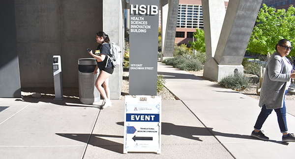 [A student enters the HSIB Forum, where the 2024 Translational Medicine Symposium was hosted by the UArizona Cancer Center and Arizona Biomedical Research Centre, 3.22.24.]