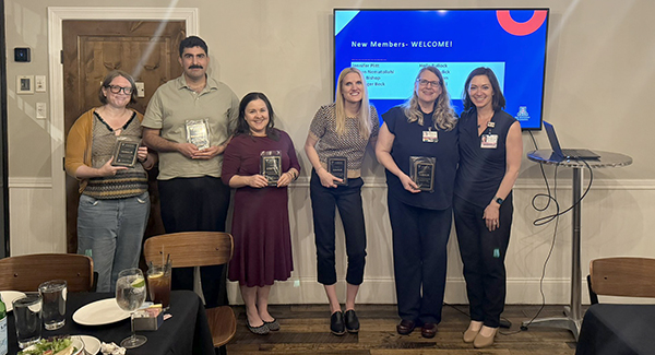 [Chair of the UArizona Chapter of the Academy of Medical Education Scholars, or AMES, Tara Carr, MD (far right), presents plaques to newly inducted members, Holly Bullock, MD, MPH (OB-GYN), Saman Nematollahi, MD (Infectious Diseases), Joy Bulger Beck, MD (GGP-General Internal Medicine), Jennifer Plitt, MD (GGP-Palliative Medicine), and Amy Mitchell, MD (OB-GYN). Missing from the photo are other new members, Maria Bishop, MD (Hematology-Oncology), Steven Dudick, MD (OB-GYN), and Aaron Mason, MD (Surgery).]